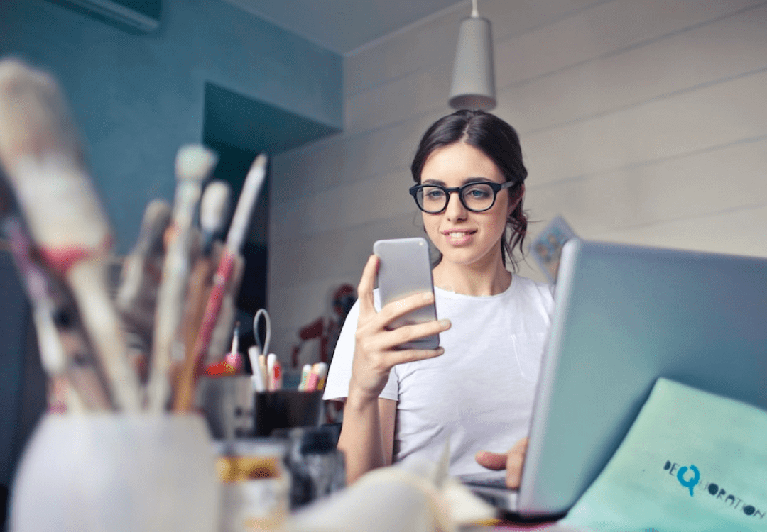 Woman wearing glasses holding a phone Woman wearing glasses holding a phone