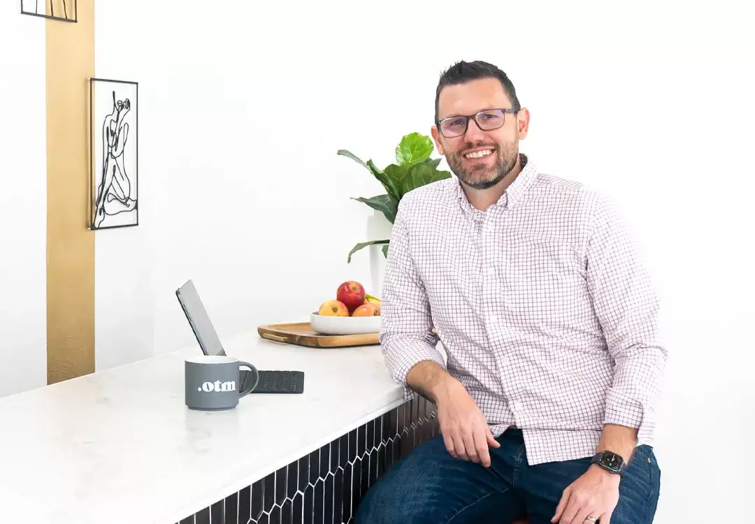 man smiling by a computer