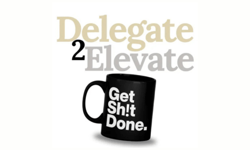 A black mug with the words "Get Sh!t Done." in bold white letters is in front of the phrase "Delegate 2 Elevate" written in large, overlapping beige and gray text.